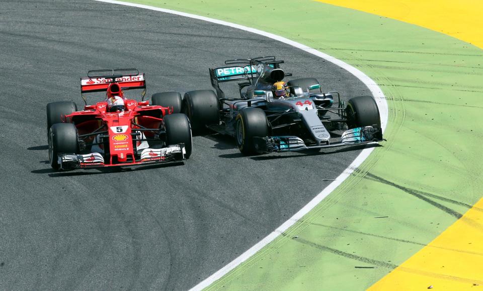 Sebastian Vettel and Lewis Hamilton race side-by-side on track